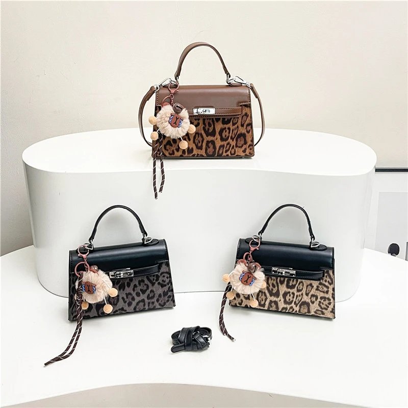Leopard Print Handbag with Faux Fur Charm and Adjustable Strap