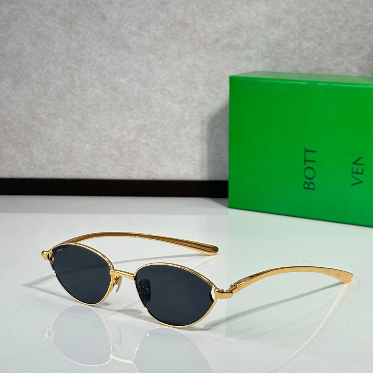 Bottega Veneta Gold Frame Sunglasses with Dark Lenses